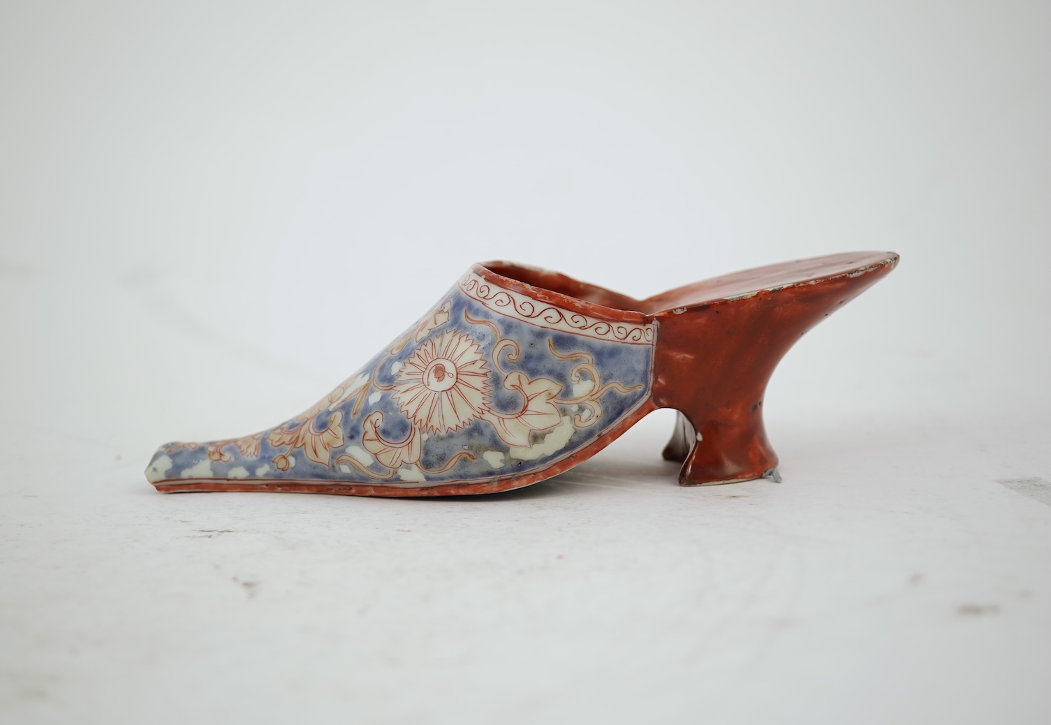 A rare Japanese Arita or Chinese porcelain model of a shoe, based on a Delft shape, first half of 18th century